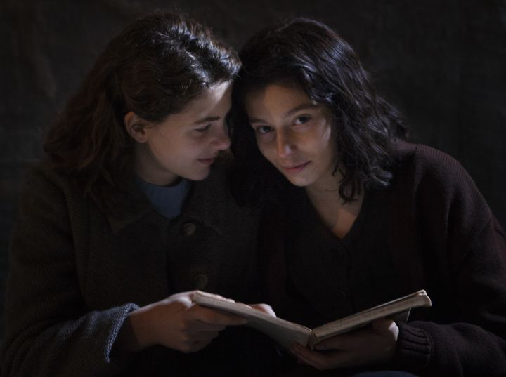 Elena and Lila of My Brilliant Friend HBO series reading a book together.
